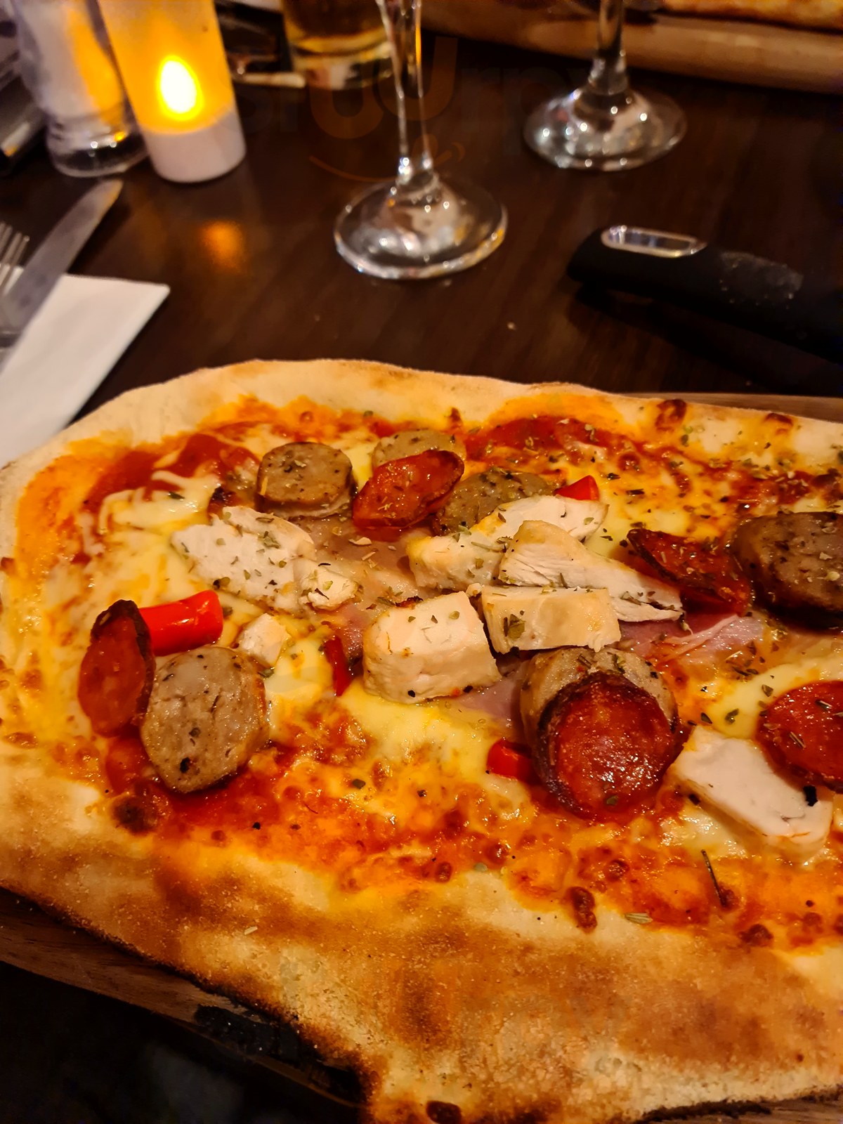 Meat feast pizza with wine at Il Piatto